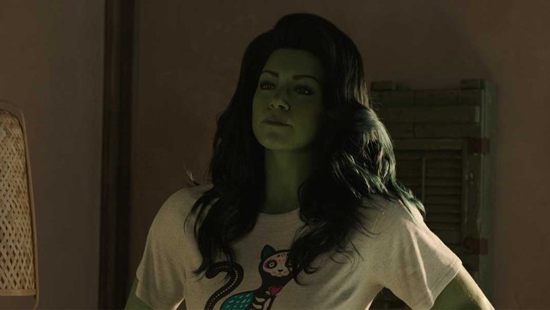 Actress Tatiana Maslany with CGI green skin and hair and wearing a graphic T-shirt.
