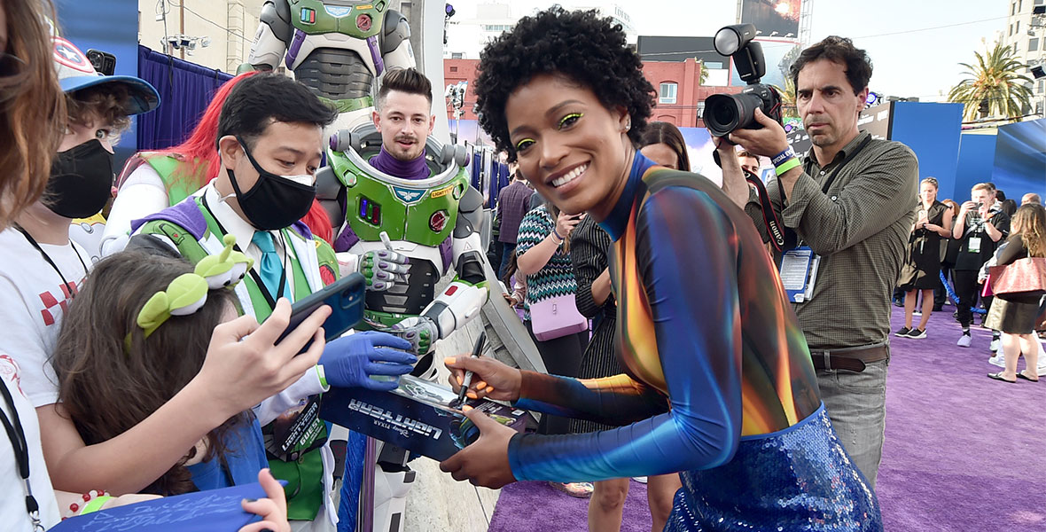 Keke Palmer, who voices Izzy Hawthorne in Lightyear, signs autographs for fans at the film’s world premiere.