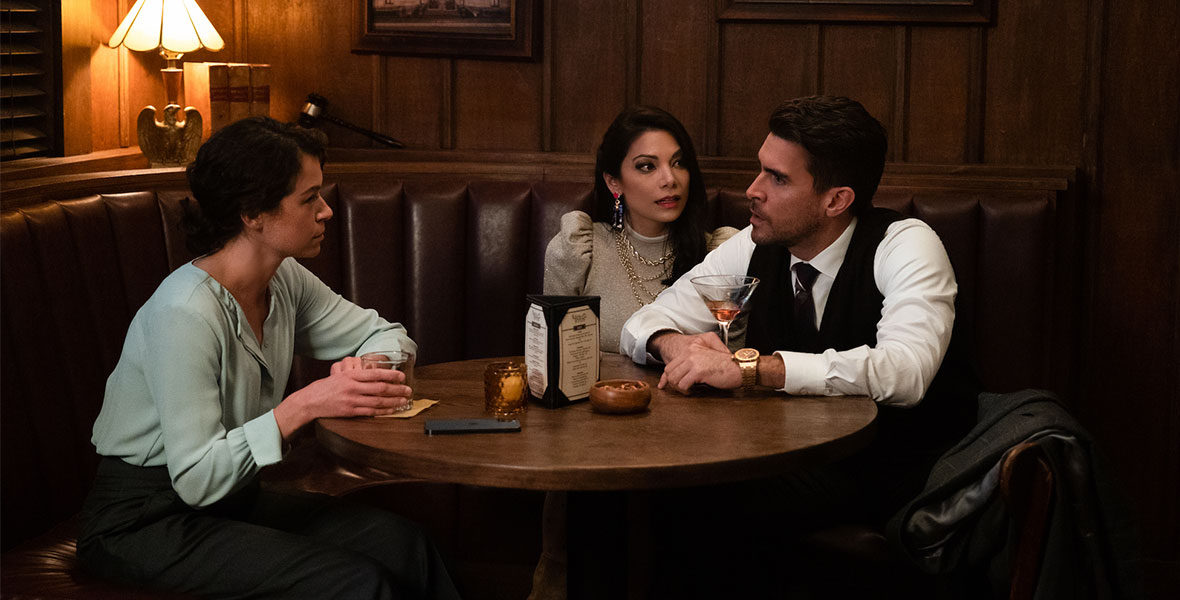 (Left to Right) Actors Tatiana Maslany as Jennifer Walters/She-Hulk, Ginger Gonzaga as Nikki Ramos, and Josh Segarra as Augustus “Pug” Pugliese sit at a large round table, talking. 