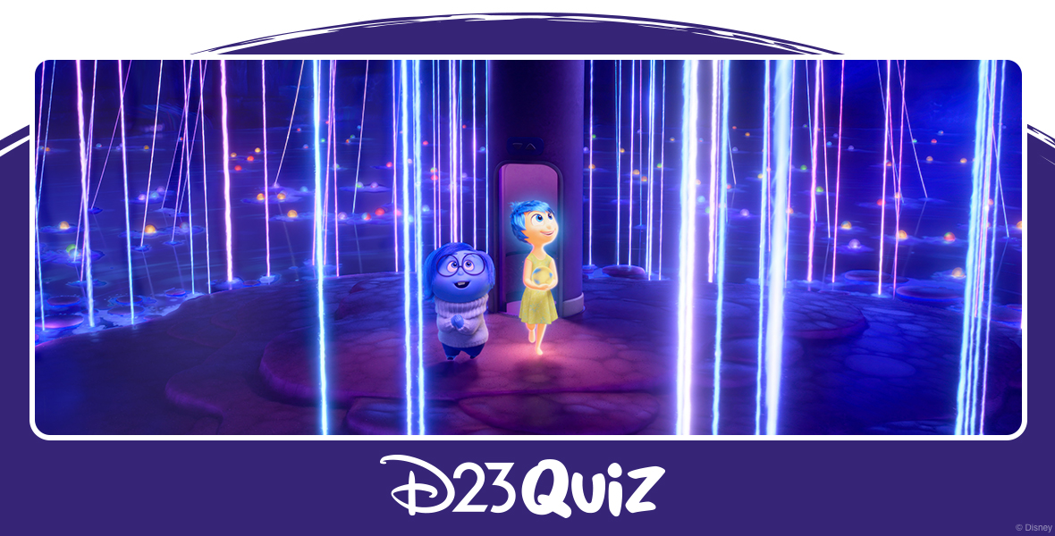 In a scene from Inside Out 2, Sadness (voiced by Phyllis Smith) and Joy (voiced by Amy Poehler) are standing on a dark blue island, surrounded by dark blue water. Neon-colored spheres with neon rays extending upward are scattered around the island and in the water. Behind Joy is a purple cylinder with a door-sized opening at its base. Both Joy and Sadness look upwards, amazed.