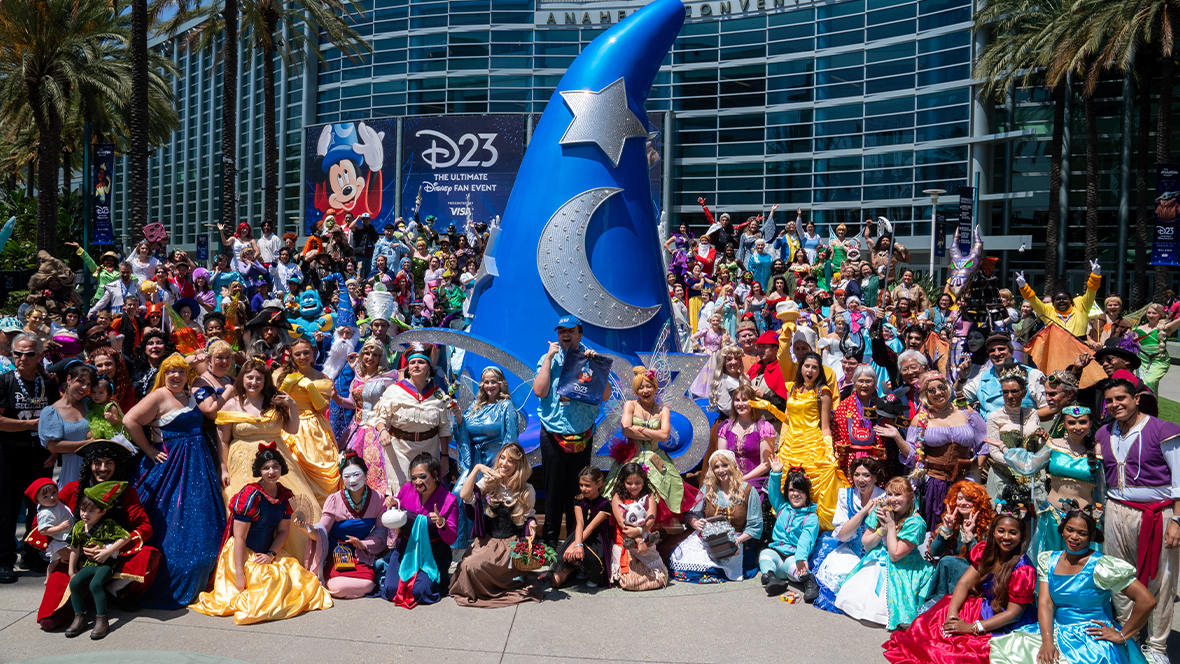 D23 Events Cosplayers gathered around a Sorcerer's Hat statue at D23: The Ultimate Disney Fan Event.