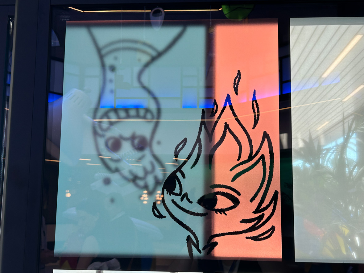 An illustration of Ember and Wade from Elemental on a sliding glass door. Ember is on the front glass door, her head poking up from the black frame surrounding her. Wade is blurrier, as he is on the back glass door, upside down and against a blue background.